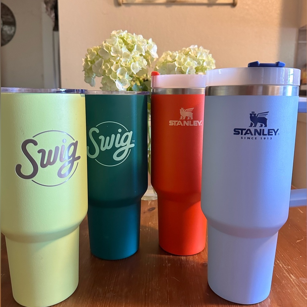 Four 40 oz tumblers. All used, but good condition. 2 Swig tumblers & 2 Stanley